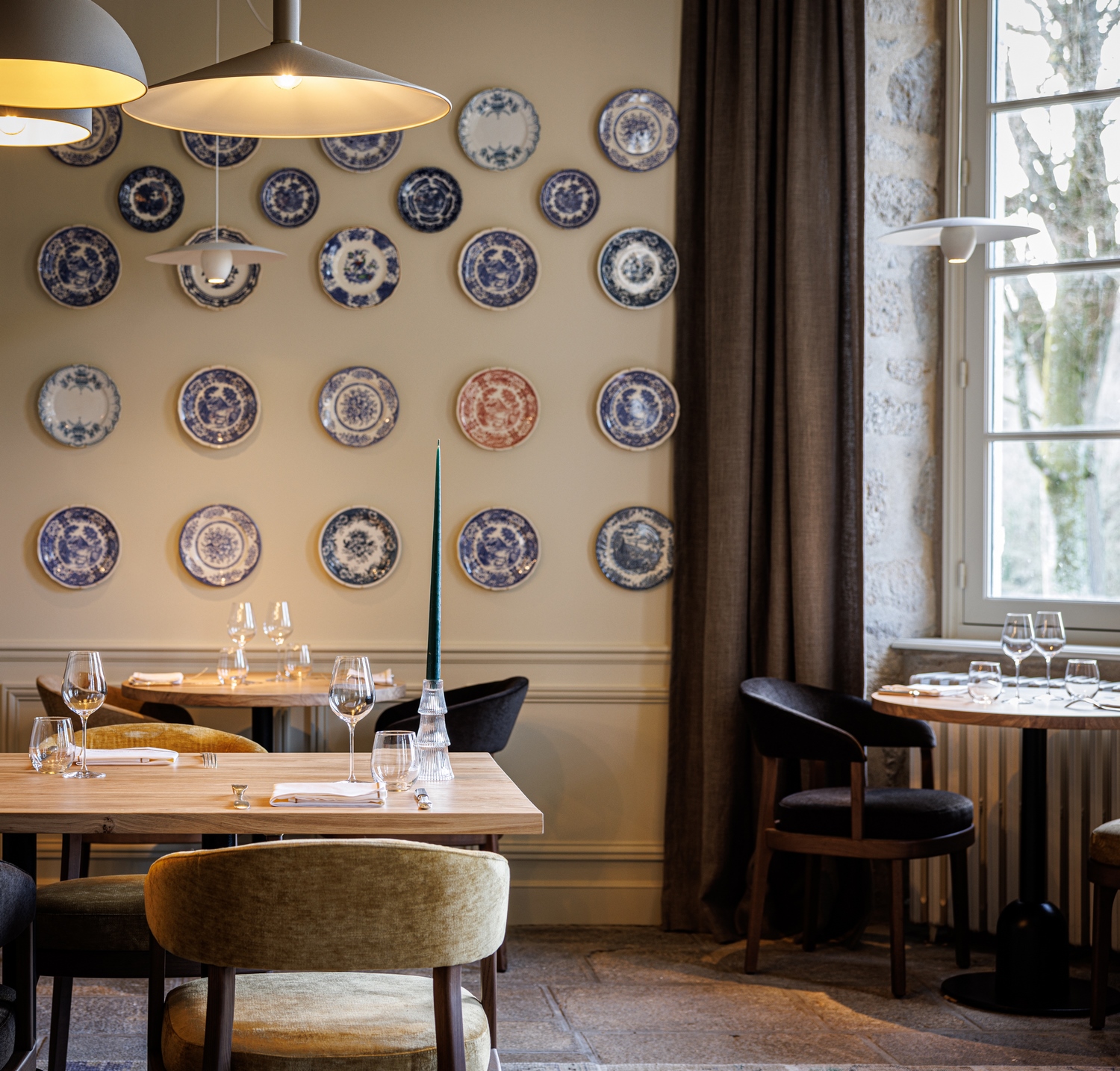 Set of porcelain plates covering a wall in our gourmet restaurant in a luxury hotel by the sea in Morbihan in Brittany.