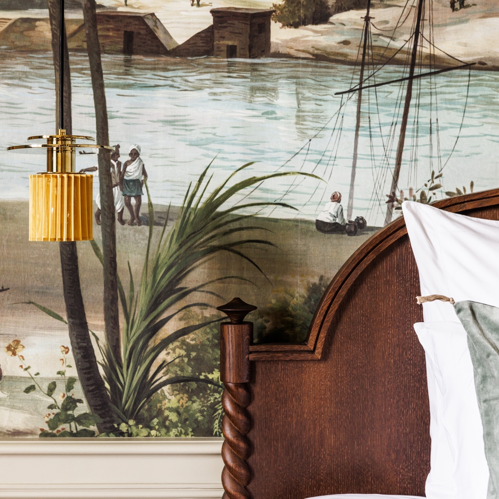 Wooden headboard on a historic river tapestry in our prestige sea suite at the château de locguénolé in bretagne