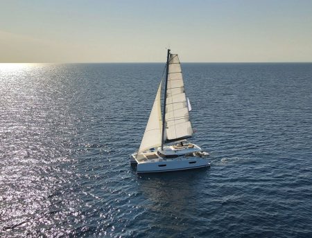 Sail Catamaran Floating At Calm Sea Aerial Photo voilier en mer - relais et chateaux bretagne